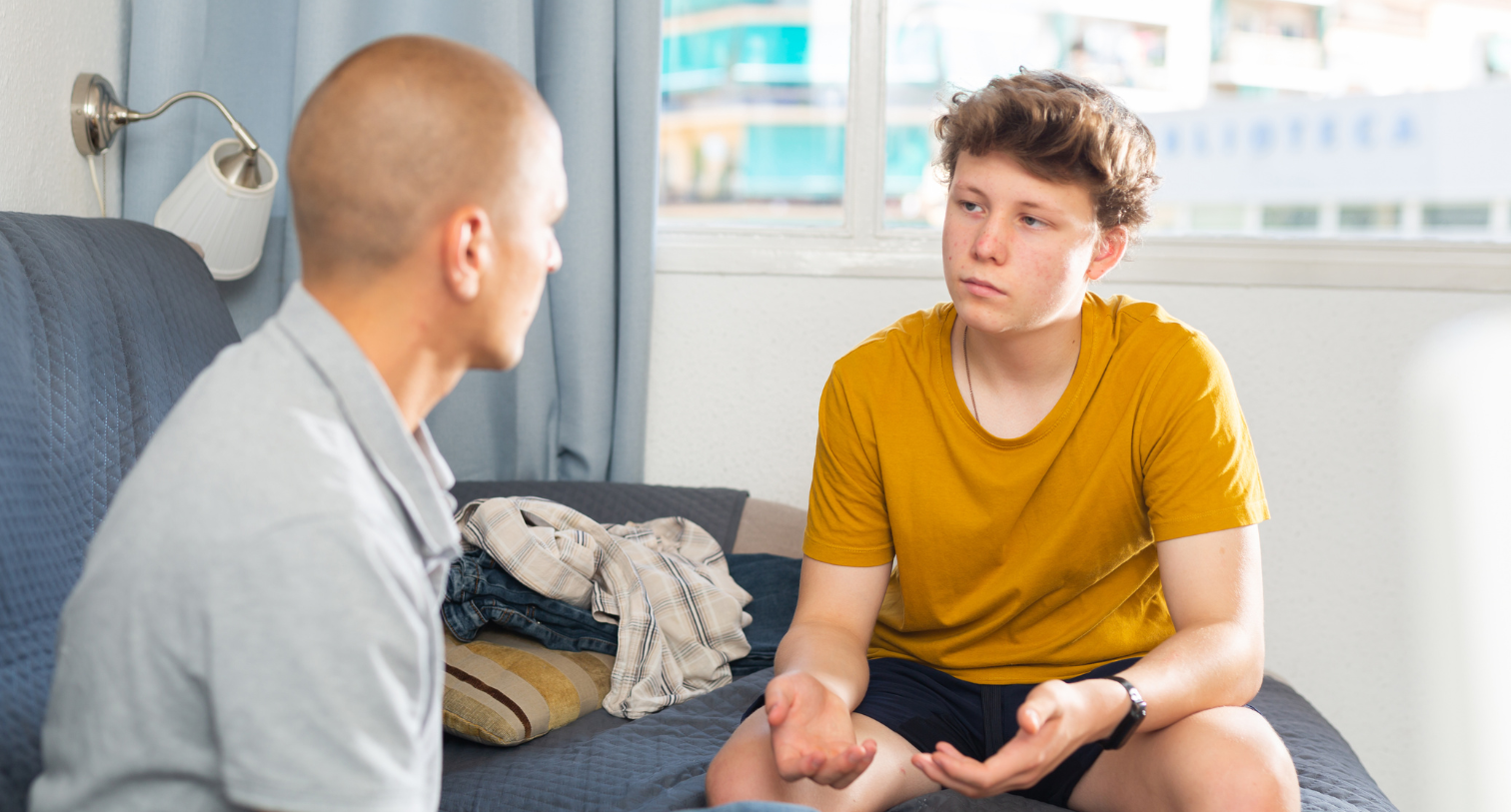 Dad and teenager son having conversation