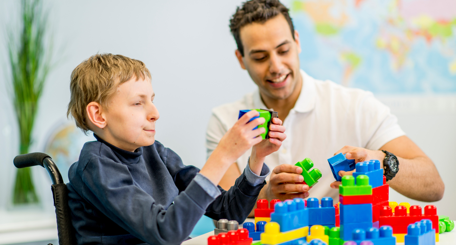 Dad playing lego with his disabled son
