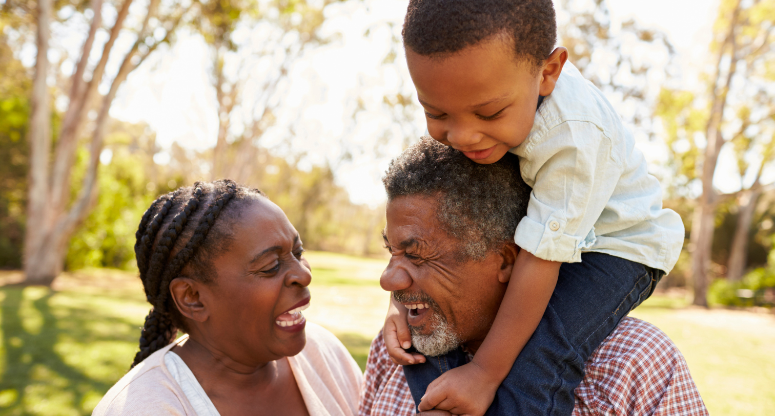Grandparents and Grandson Having Fun in Park Together