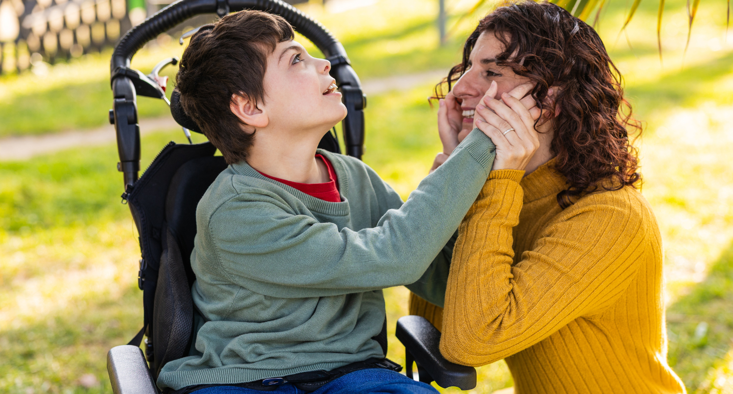 child playing with mother outdoors in wheelchair, cerebral palsy and intellectual disability awareness
