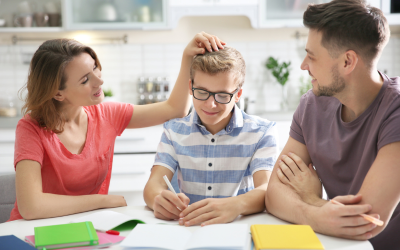 Mum and dad comforting their teenage son on the dining room table