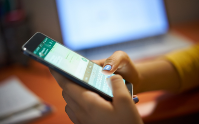 A person holding and looking through their smartphone