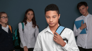 boy feeling left out with other pupils behind him
