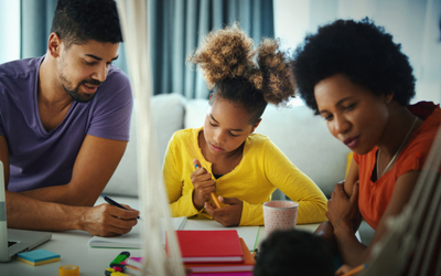 Mum and dad with her child doing some homework