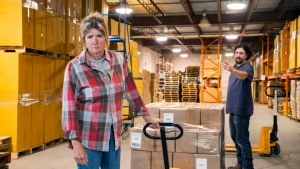 Woman experiencing bullying at work in a warehouse